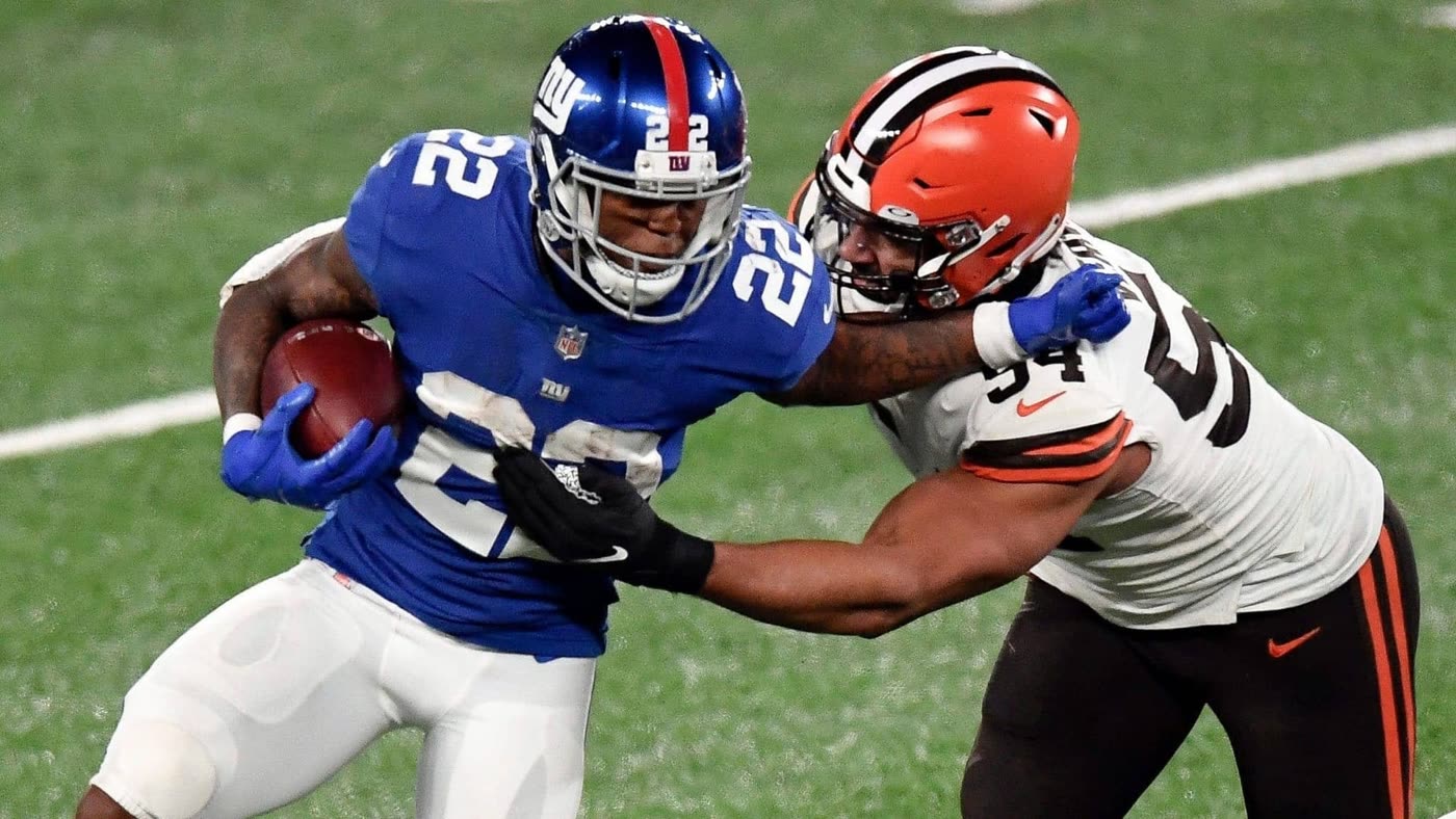 Wayne Gallman stiff-arms a defender